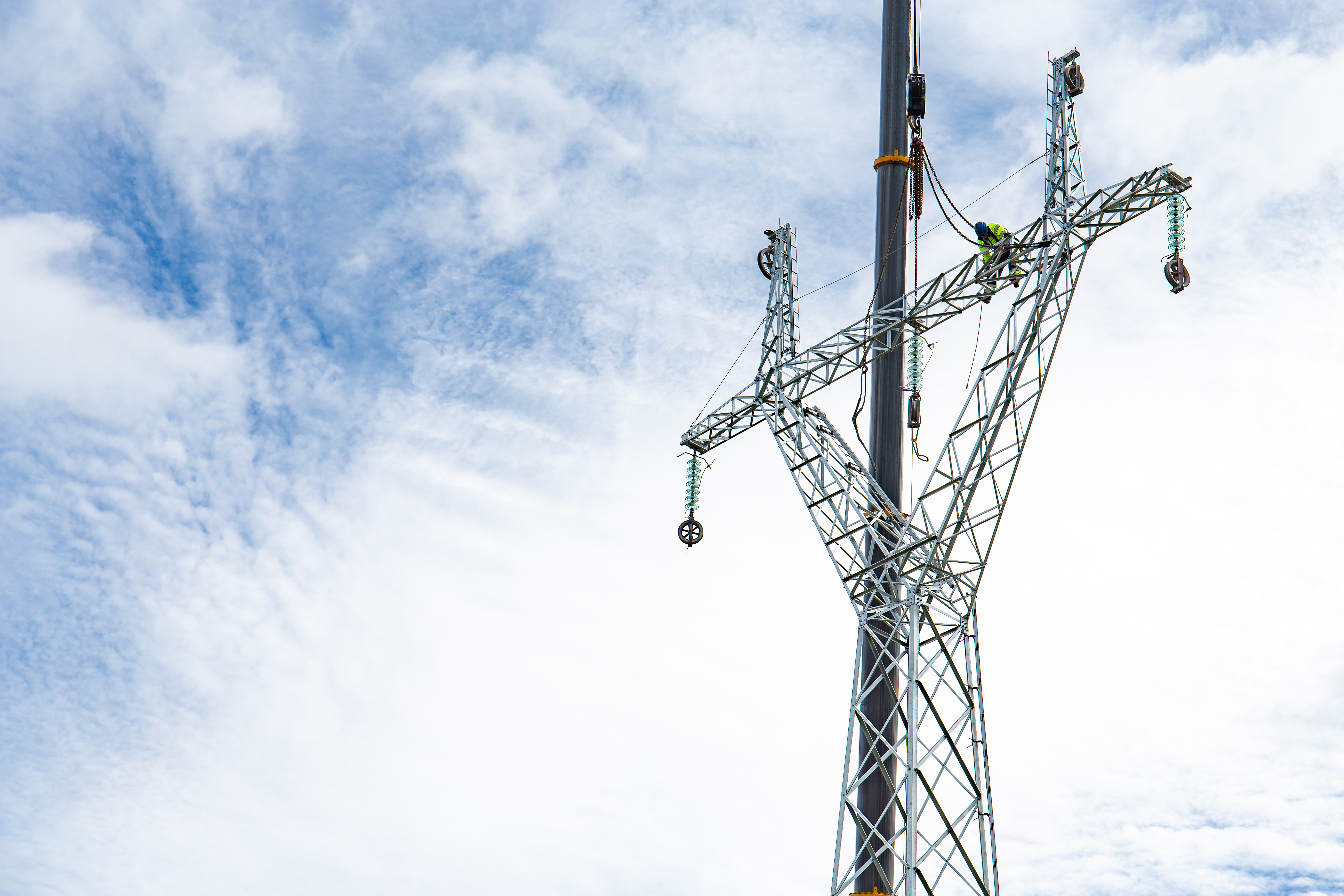 An illustration of two individuals standing back‑to‑back with arms crossed. Behind them are several checkmark icons in orange tones, symbolizing approval, completion, or confidence.