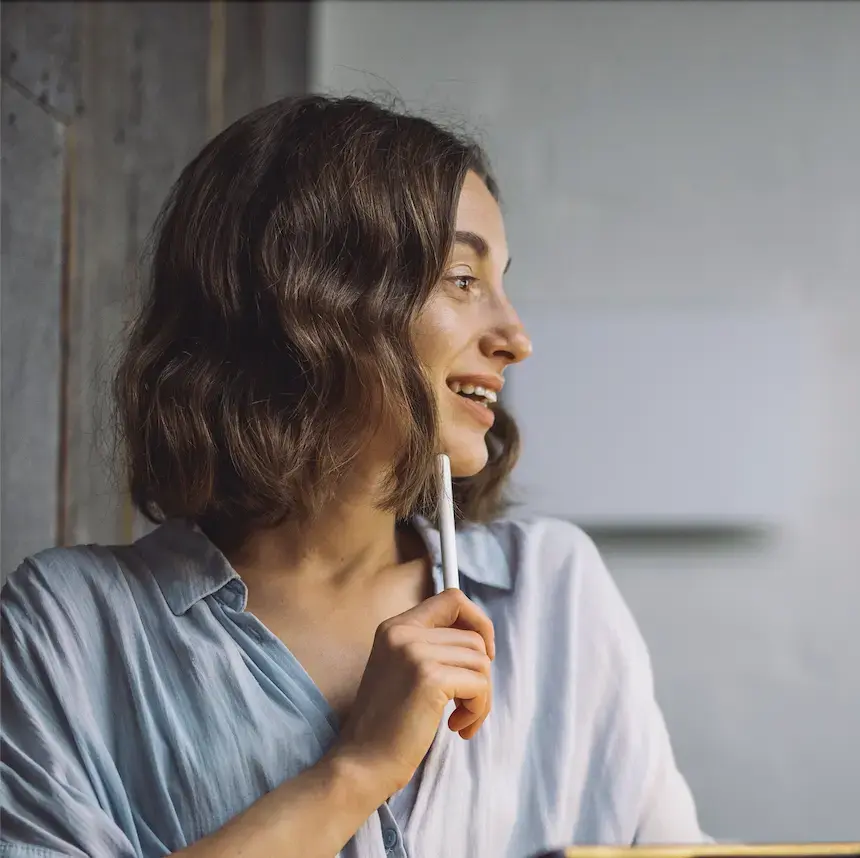 A woman sitting at a table with a tablet in her hand